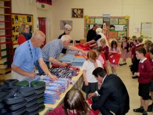 Rotarians and children pack bags in 2014